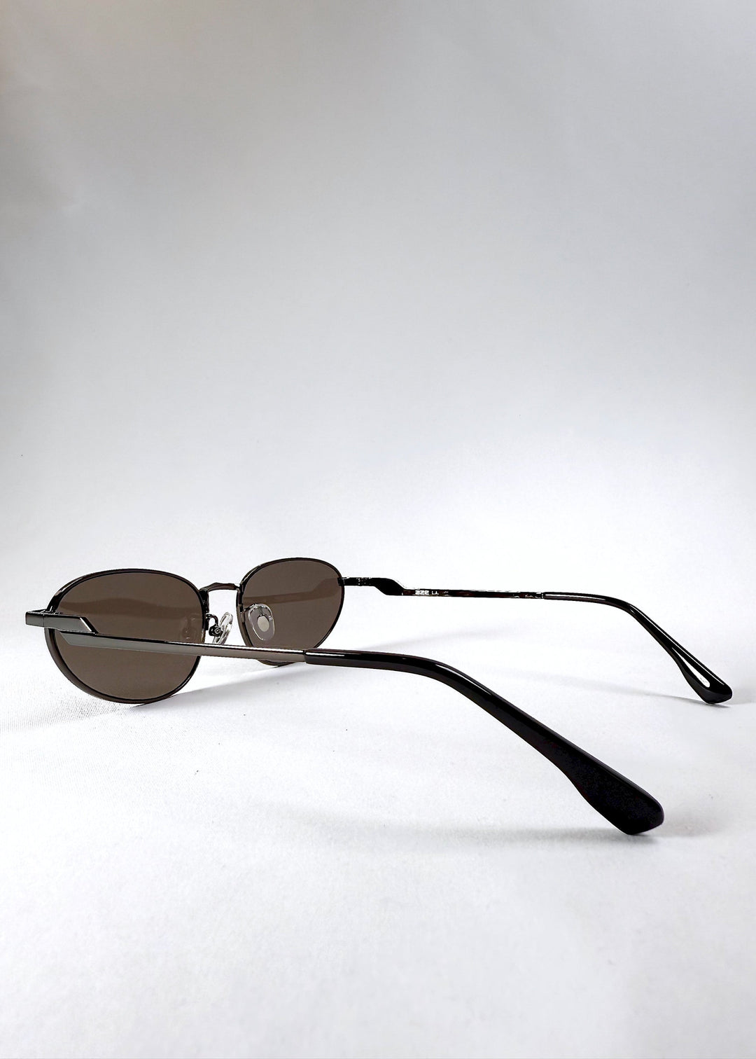 Side profile view highlighting the curved temples and satin gunmetal finish of the Lunaris - Iron Ember frame. 