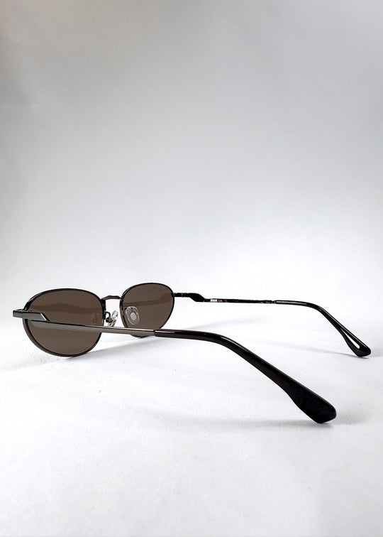 Side profile view highlighting the curved temples and satin gunmetal finish of the Lunaris - Iron Ember frame. 