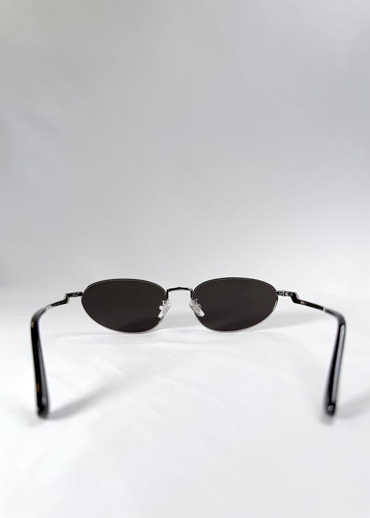 Rear view of Lunaris - Moonlit Silver sunglasses, showing temple alignment and thin frame arms. 