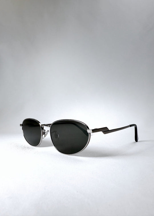 Front angle view of Lunaris - Moonlit Silver sunglasses, highlighting the soft metallic sheen and ergonomic curve. 