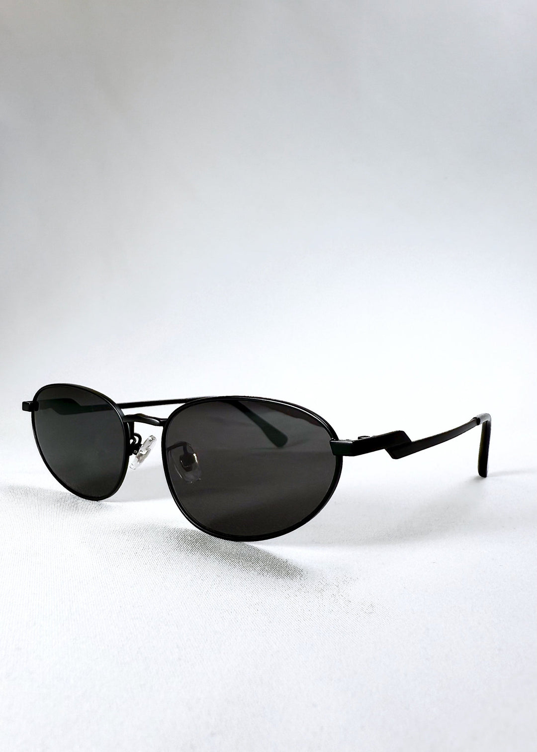Angled front view of Lunaris - Shadow Black showing its semi-matte finish and teardrop lens shape. 