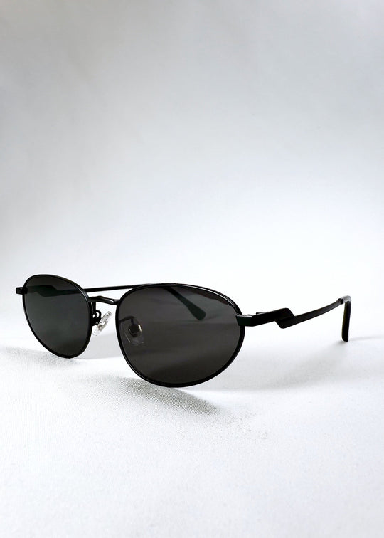 Angled front view of Lunaris - Shadow Black showing its semi-matte finish and teardrop lens shape. 