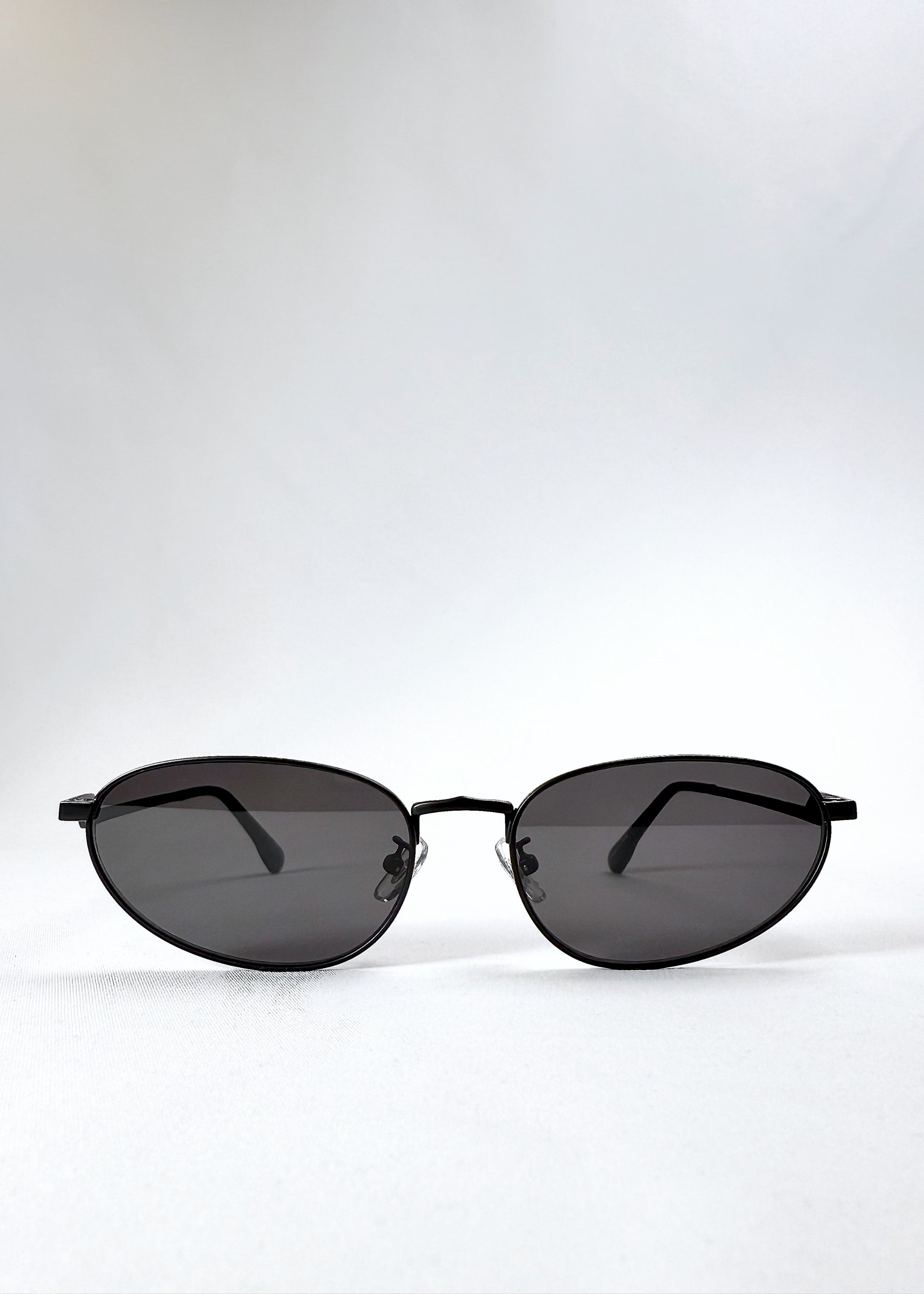 Front view of Lunaris - Shadow Black sunglasses showing the classic aviator silhouette and dark grey lenses.