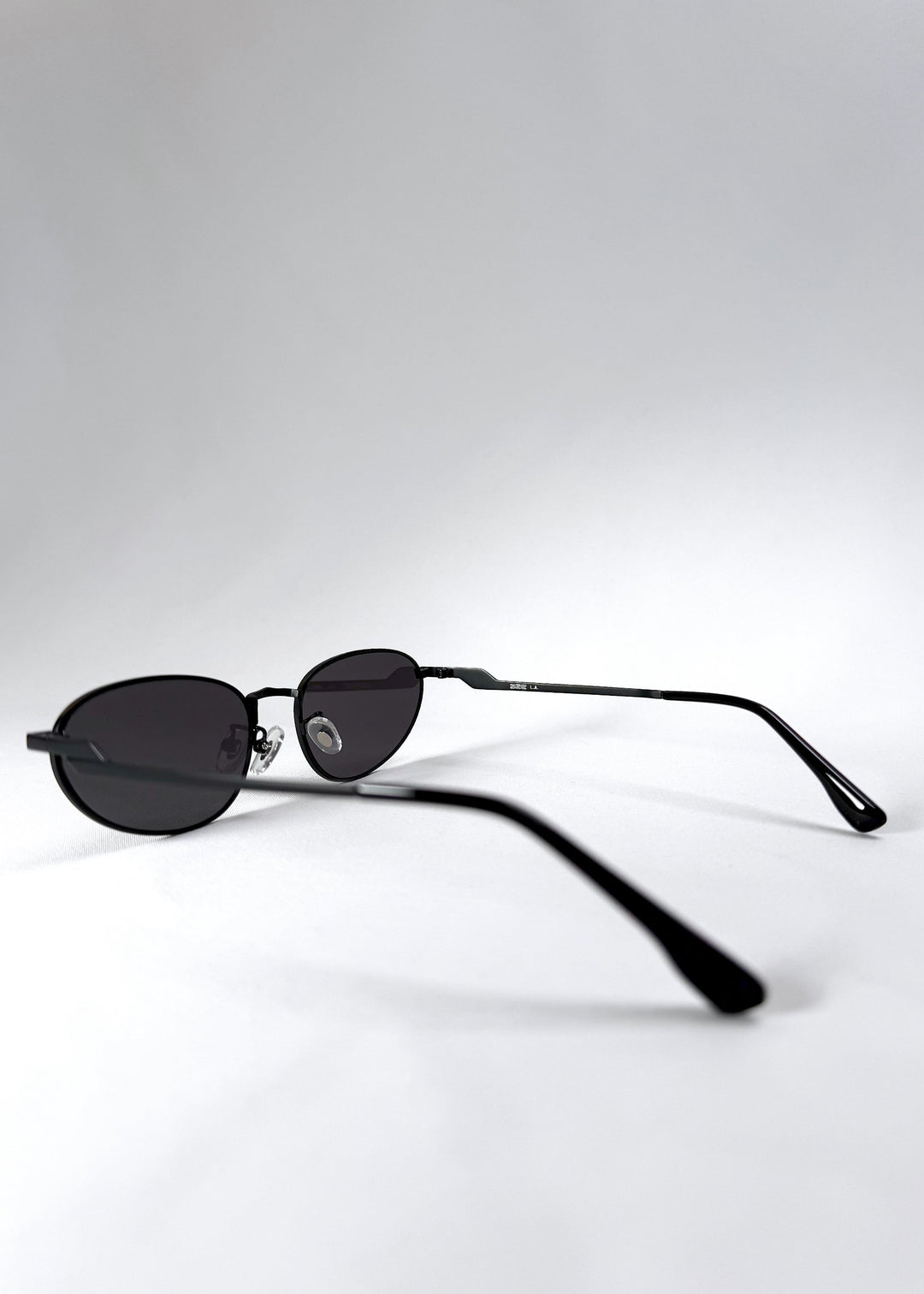 Side view of Lunaris - Shadow Black featuring the slim temples and curved earpieces. 