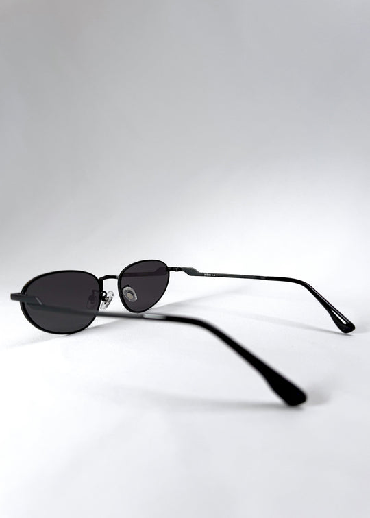 Side view of Lunaris - Shadow Black featuring the slim temples and curved earpieces. 