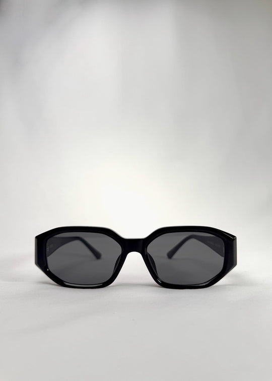 Front view of Lyra sunglasses in Black, featuring a glossy black acetate frame, angular lens shape, and UV400 lenses, showing the full front silhouette. 