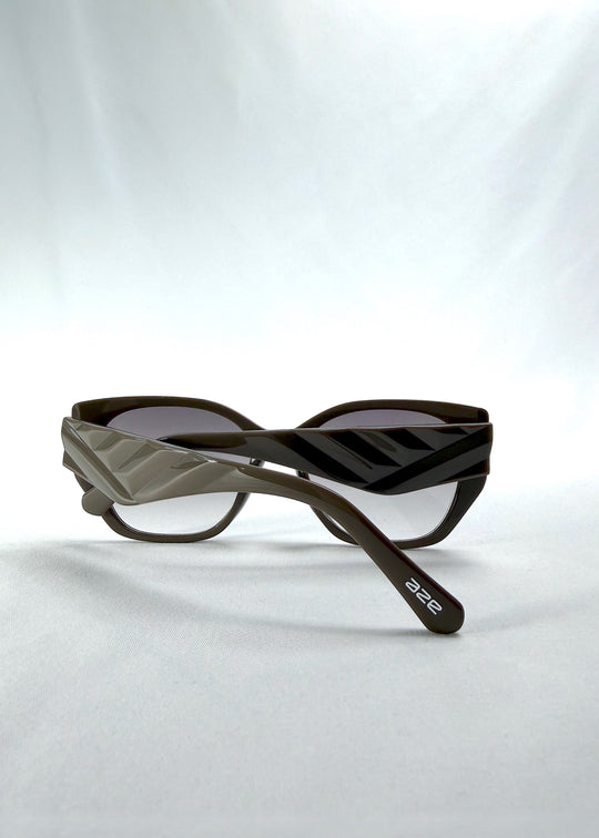 Folded view of Marlowe sunglasses in Graphite Haze, featuring grey-brown acetate frame and smoky lenses, showing the folded temples and frame profile.