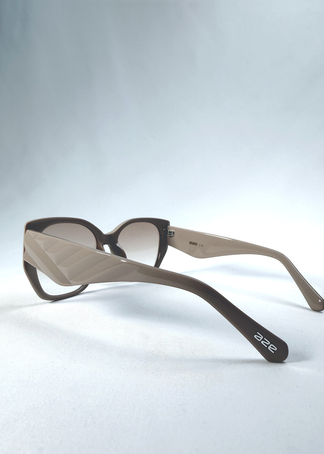 Back-angle view of Marlowe sunglasses in Mauve Mist, featuring a sculpted translucent mauve acetate frame and soft gradient lenses, showing the rear frame structure and temple alignment.