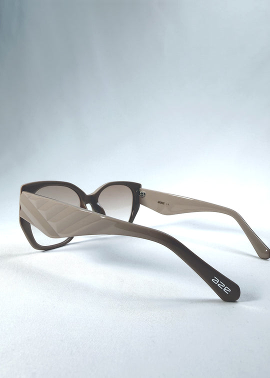 Back-angle view of Marlowe sunglasses in Mauve Mist, featuring a sculpted translucent mauve acetate frame and soft gradient lenses, showing the rear frame structure and temple alignment.