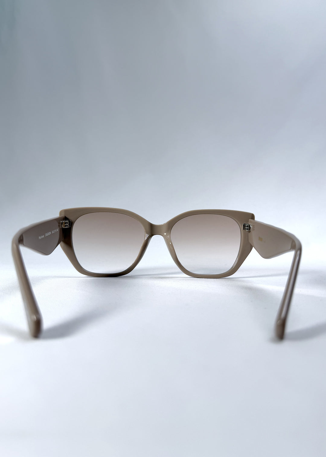 Back view of Marlowe sunglasses in Mauve Mist, featuring a sculpted translucent mauve acetate frame and soft gradient lenses, showing the inside frame and open temples.