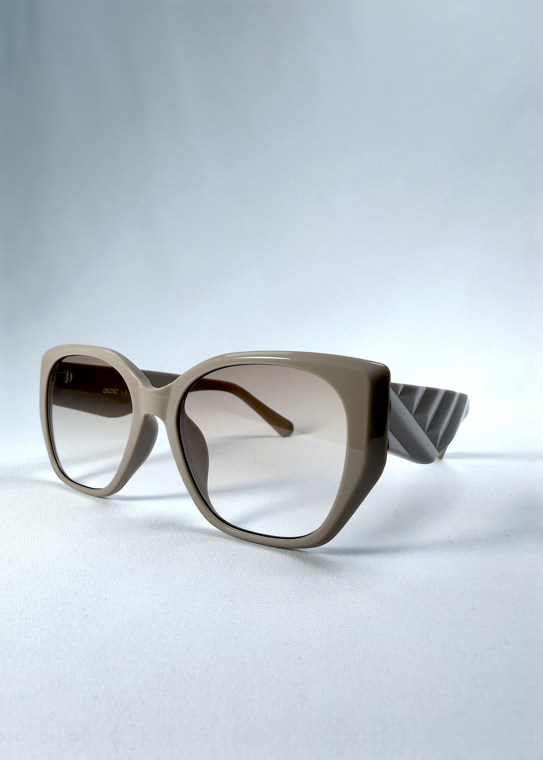 Three-quarter front view of Marlowe sunglasses in Mauve Mist, featuring a sculpted translucent mauve acetate frame and soft gradient lenses, showing the frame shape and temple profile.