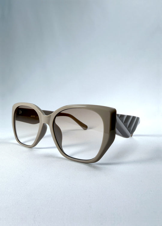 Three-quarter front view of Marlowe sunglasses in Mauve Mist, featuring a sculpted translucent mauve acetate frame and soft gradient lenses, showing the frame shape and temple profile.