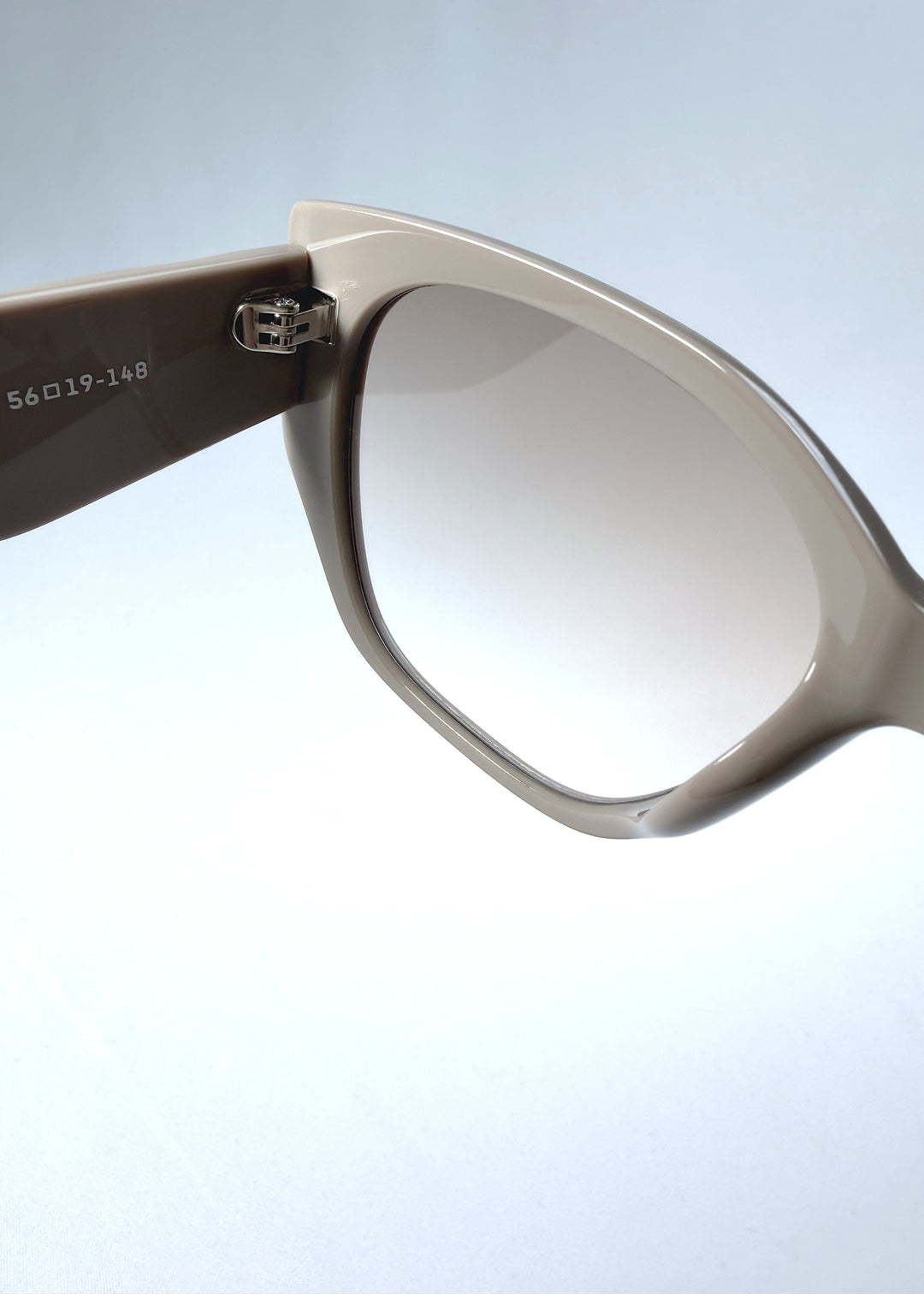 Close-up hinge detail view of Marlowe sunglasses in Mauve Mist, featuring a sculpted translucent mauve acetate frame and soft gradient lenses, showing the hinge construction, lens edge, and temple connection.