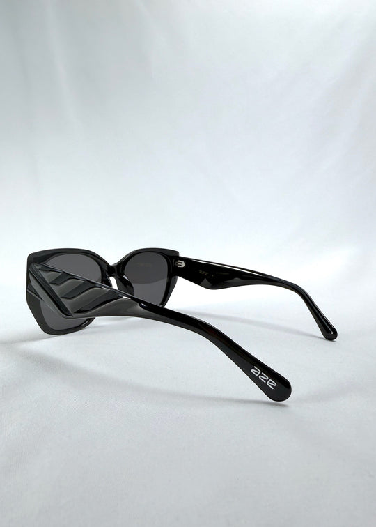 Back-angle view of Marlowe sunglasses in Obsidian Black, featuring glossy black acetate frame and dark lenses, showing the back structure and temple alignment.