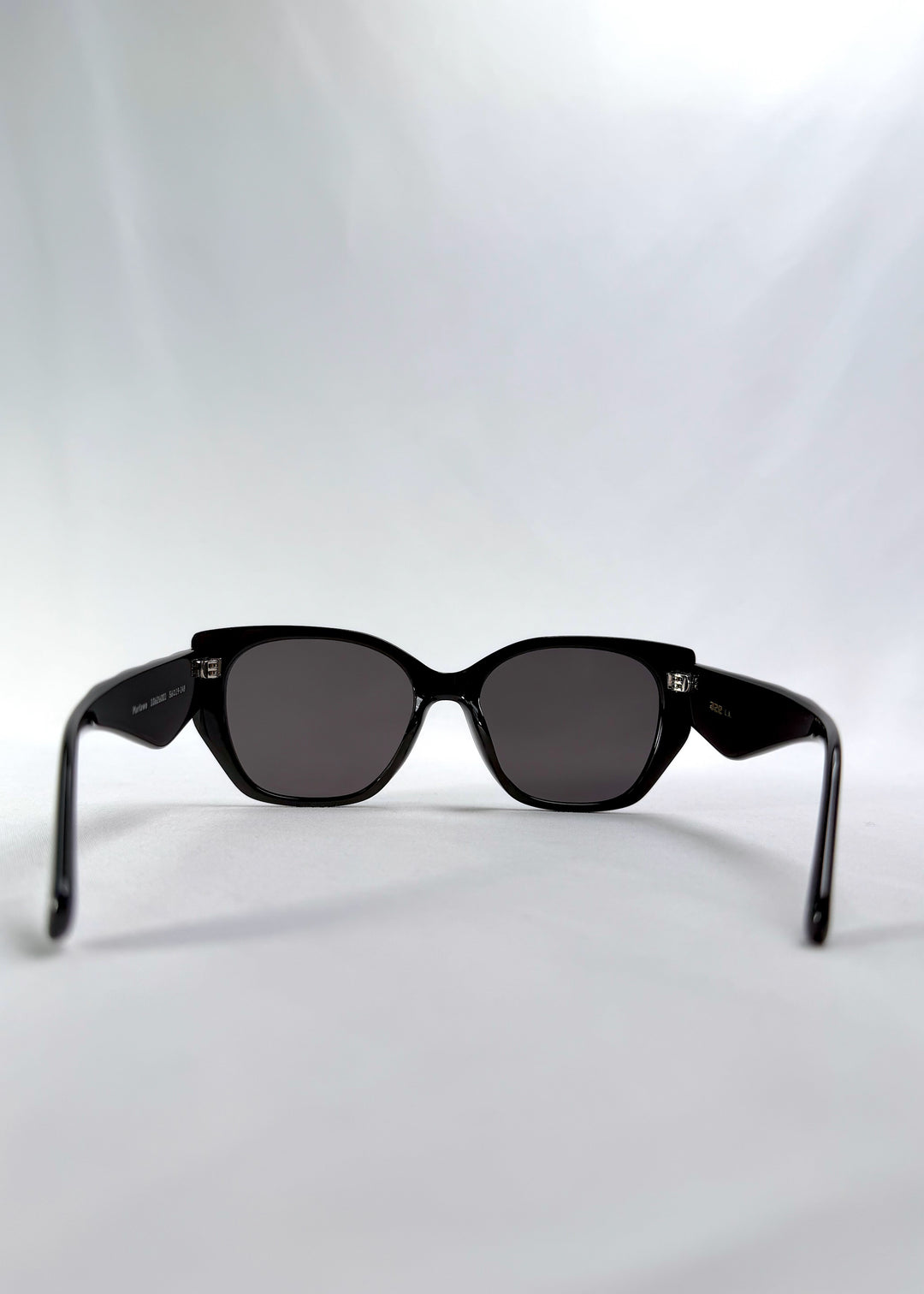 Back view of Marlowe sunglasses in Obsidian Black, featuring glossy black acetate frame and dark lenses, showing the inside frame and open temples.