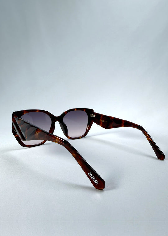 Back-angle view of Marlowe sunglasses in Tortoiseshell, featuring a sculpted tortoiseshell acetate frame and smoky gradient lenses, showing the rear frame structure and temple alignment.
