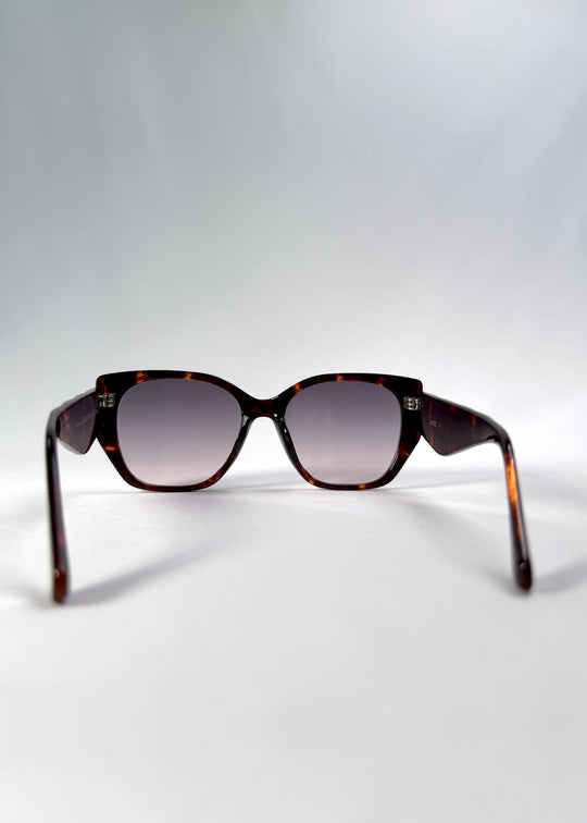 Back view of Marlowe sunglasses in Tortoiseshell, featuring a sculpted tortoiseshell acetate frame and smoky gradient lenses, showing the inside frame and open temples.