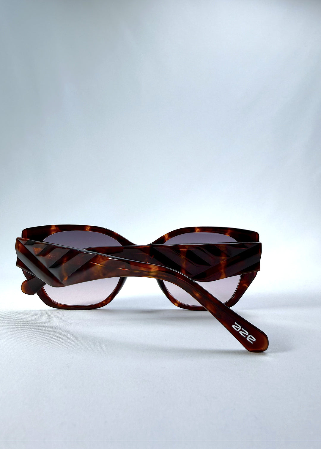 Folded view of Marlowe sunglasses in Tortoiseshell, featuring a sculpted tortoiseshell acetate frame and smoky gradient lenses, showing the folded temples and frame profile.