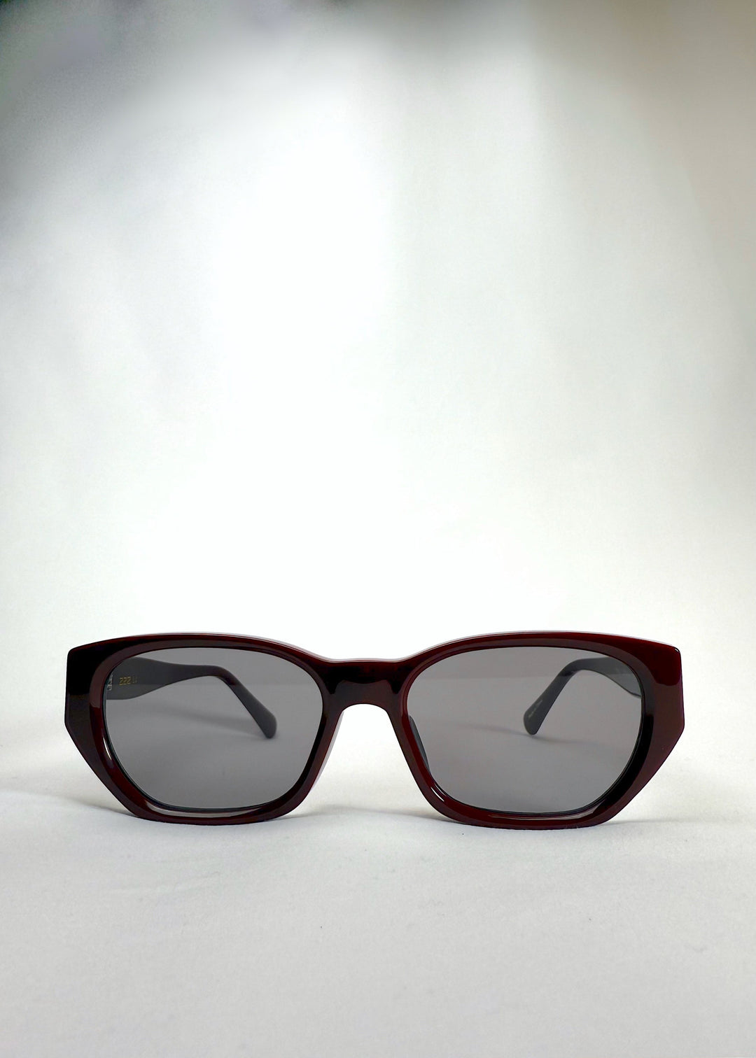Front view of Mirach sunglasses in Burgundy, featuring a deep burgundy acetate frame and gray UV400 lenses, showing the full front silhouette. 