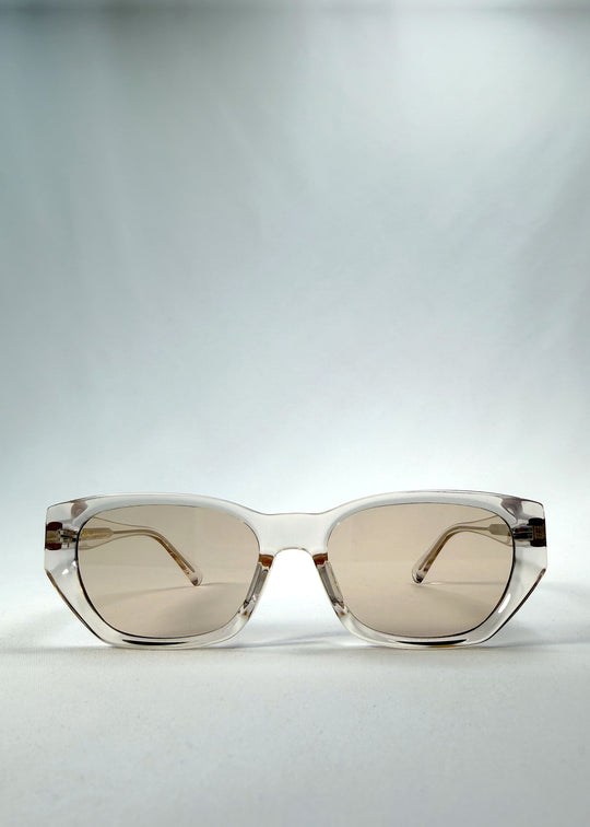 Front view of Mirach sunglasses in Transparent White, featuring crystal-clear acetate frame and tea-tinted lenses, showing the full front silhouette.