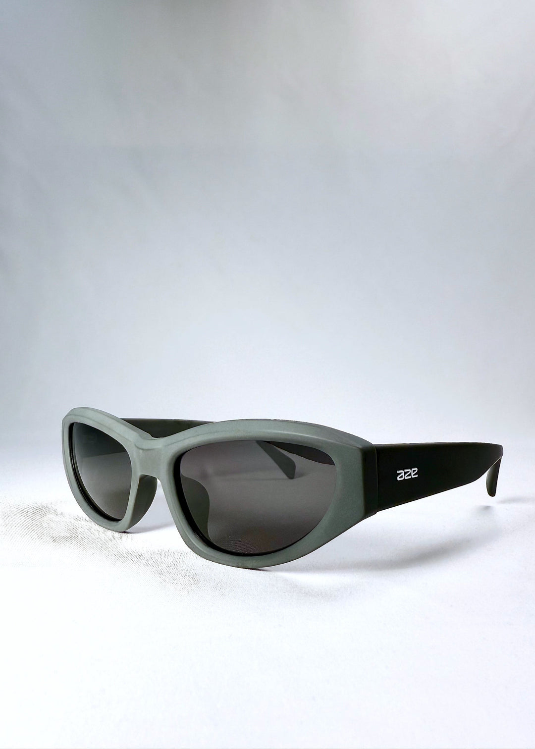 Front angle view of Nebula Shade sunglasses in Carbon Ash, highlighting the sculptural curves and wide temples. 