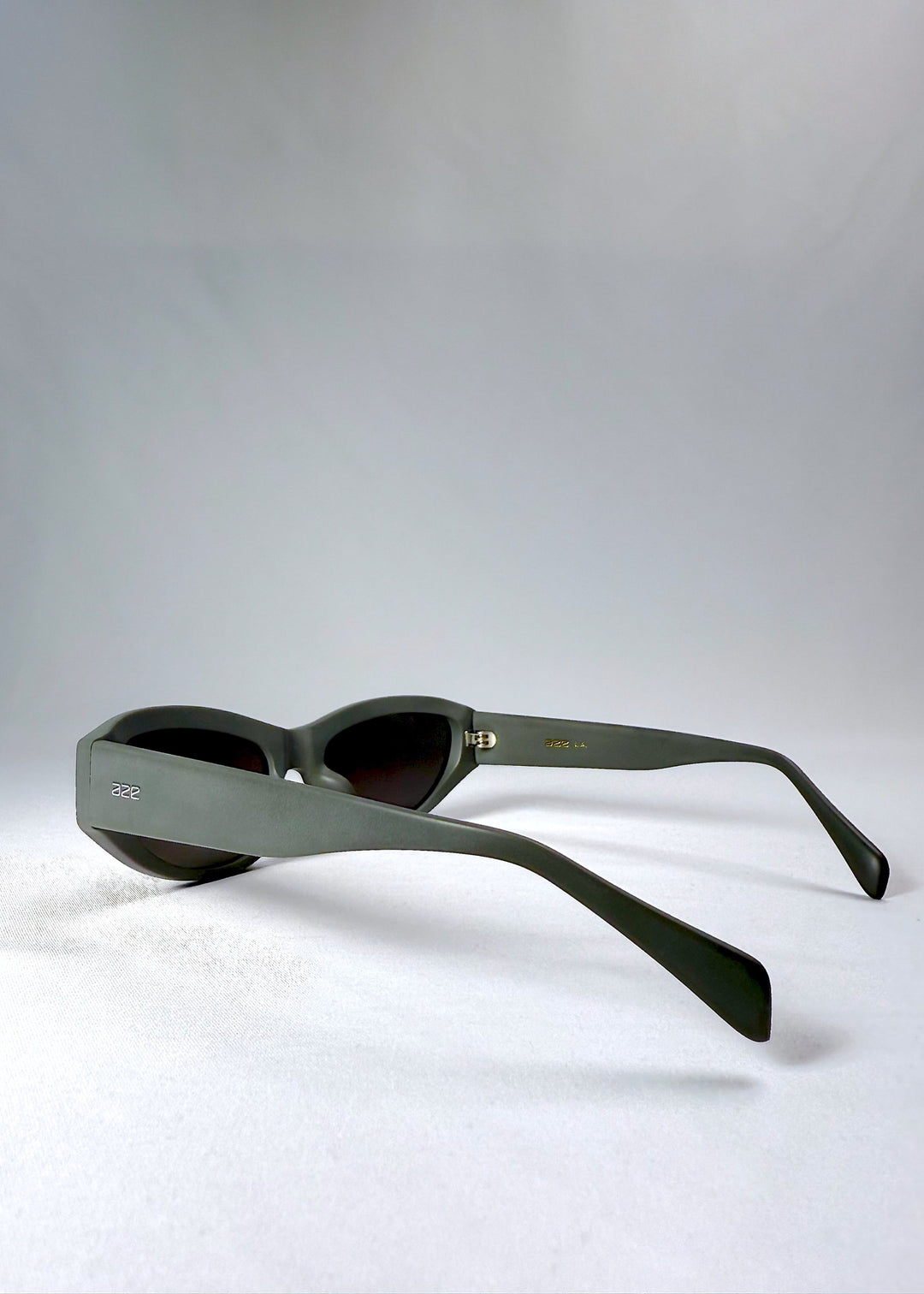 Side view of Nebula Shade sunglasses in Carbon Ash, showing the thick matte temples and engraved Aze logo. 