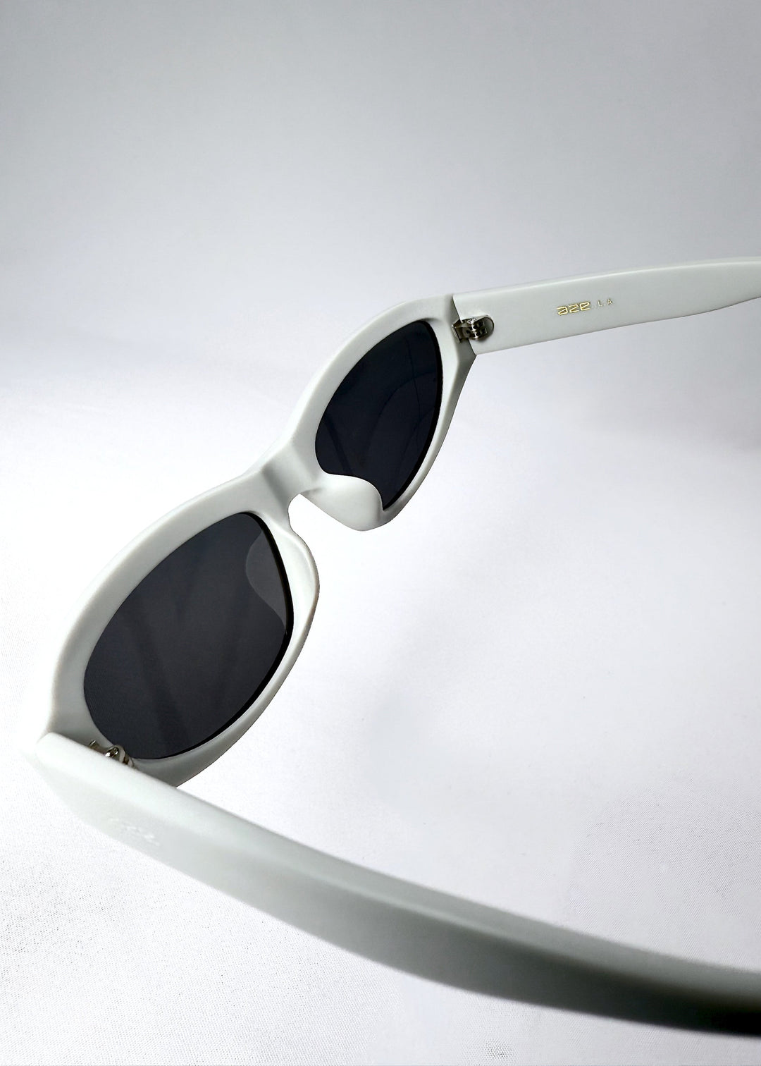 Oblique view of the dark polarized lenses in the Nebula Shade Glacial Ash frame, emphasizing UV protection and wrap fit. 