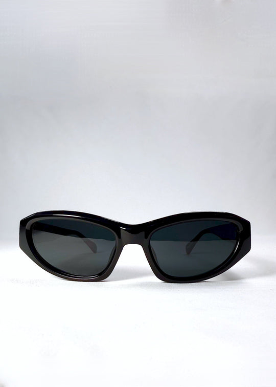 Front view of Nebula Shade sunglasses in Obsidian Black with smoky grey-green polarized lenses and glossy acetate cat-eye frame. 