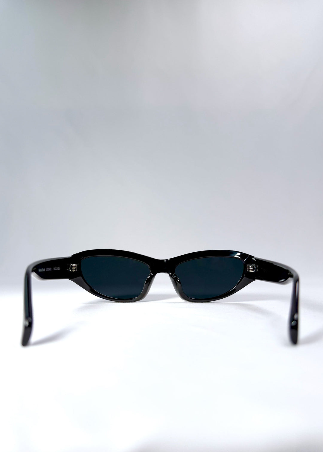 Inside view of Nebula Shade - Obsidian Black revealing frame curvature and fixed nose bridge design. 