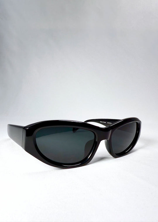 Lens closeup of Nebula Shade - Obsidian Black highlighting smoky grey-green tint and polarized coating. 
