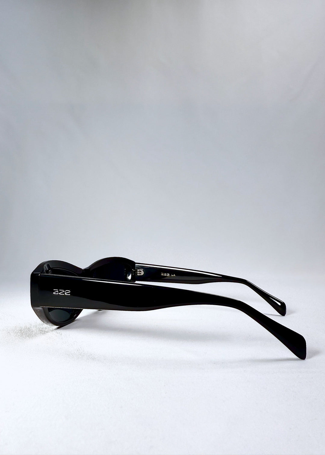 Side view of Nebula Shade sunglasses in Obsidian Black, showing the wide acetate temples and glossy black finish. 