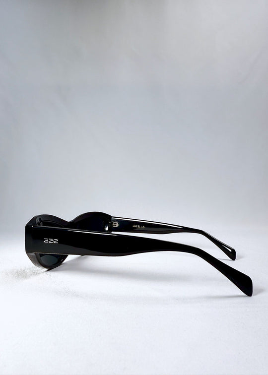 Side view of Nebula Shade sunglasses in Obsidian Black, showing the wide acetate temples and glossy black finish. 