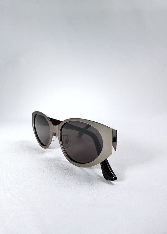 Folded view of Nyx sunglasses in Ash Steel, showing the compact frame and temple arms. 