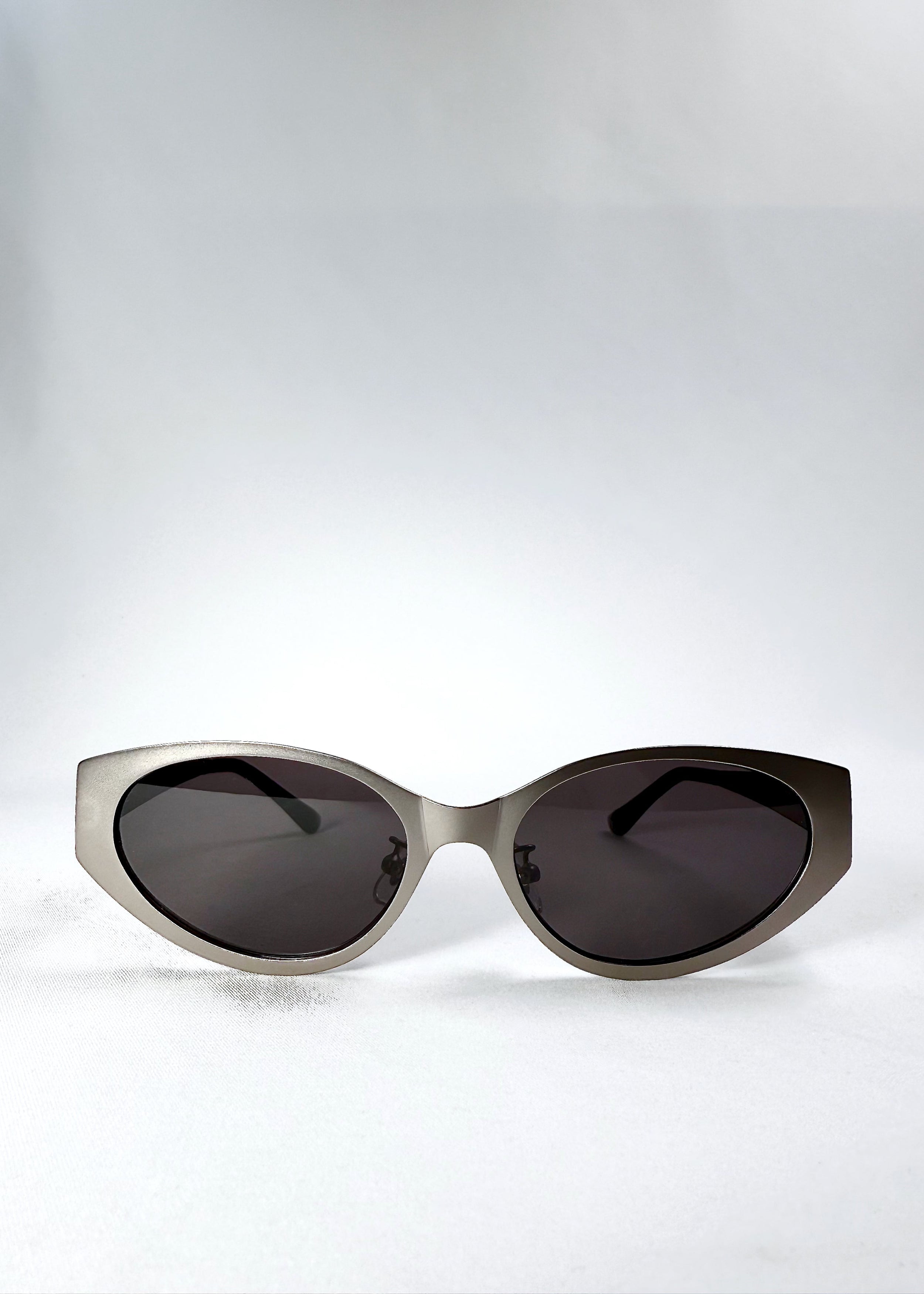 Front view of Nyx - Ash Steel sunglasses showing matte steel cat-eye frame and dark grey lenses.