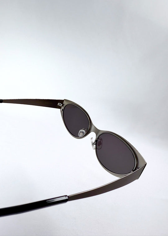 Inside view of Nyx sunglasses in Ash Steel, showing the adjustable nose pads and inner hinge structure. 