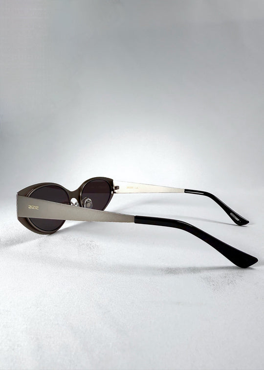 Side view of Nyx sunglasses in Ash Steel, showing the matte temple and engraved AZE logo. 