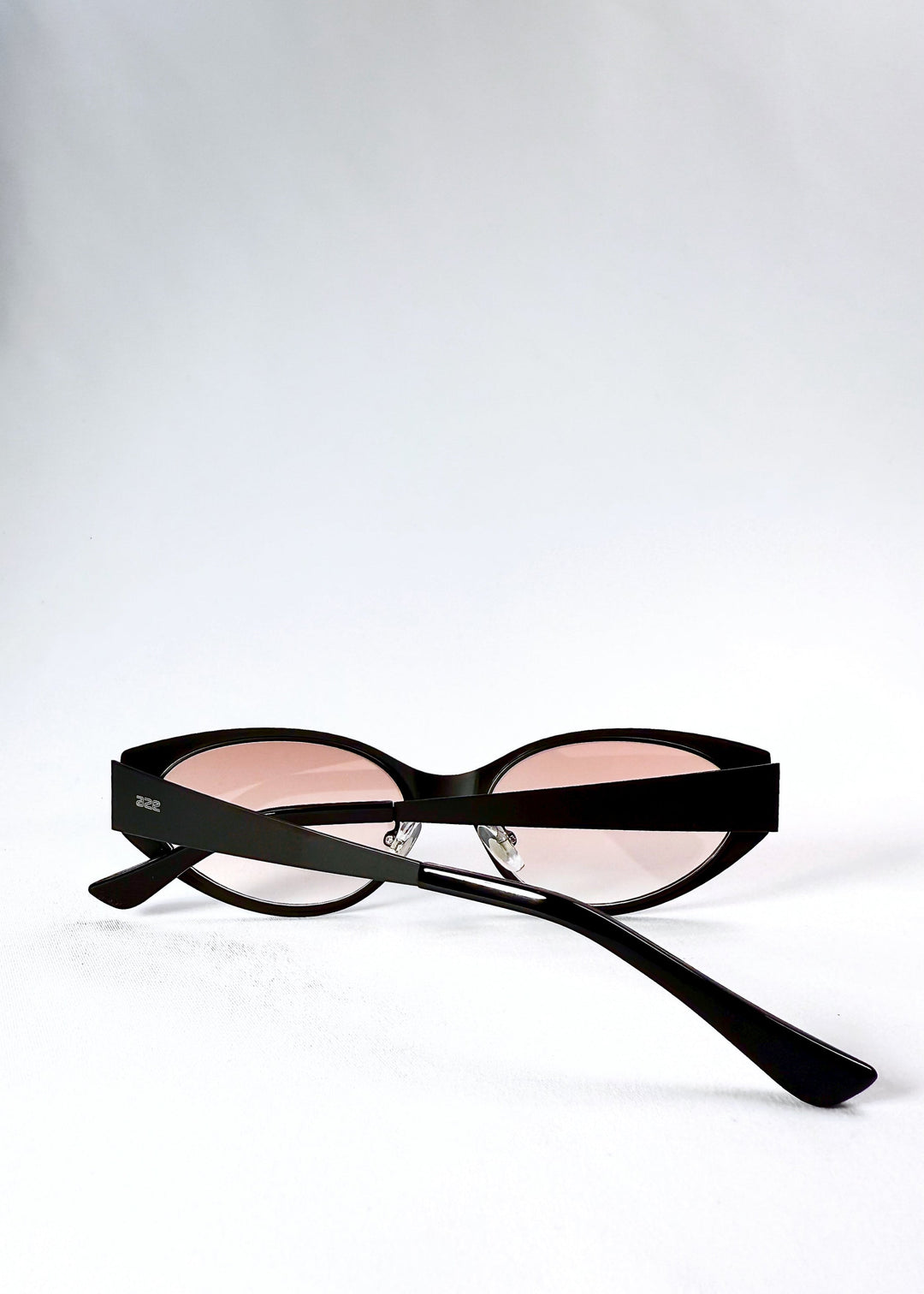 Folded view of Nyx sunglasses in Blush Eclipse, showing the compact frame and folded temples. 