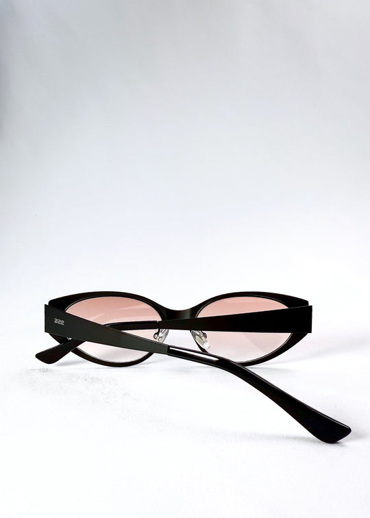 Folded view of Nyx sunglasses in Blush Eclipse, showing the compact frame and folded temples. 