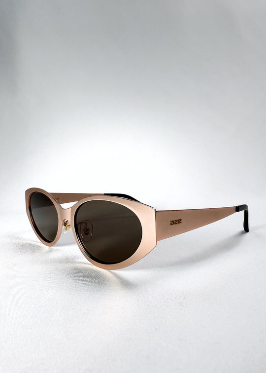 Three-quarter front view of Nyx sunglasses in Mocha Dusk, highlighting the warm bronze frame and tapered contours. 