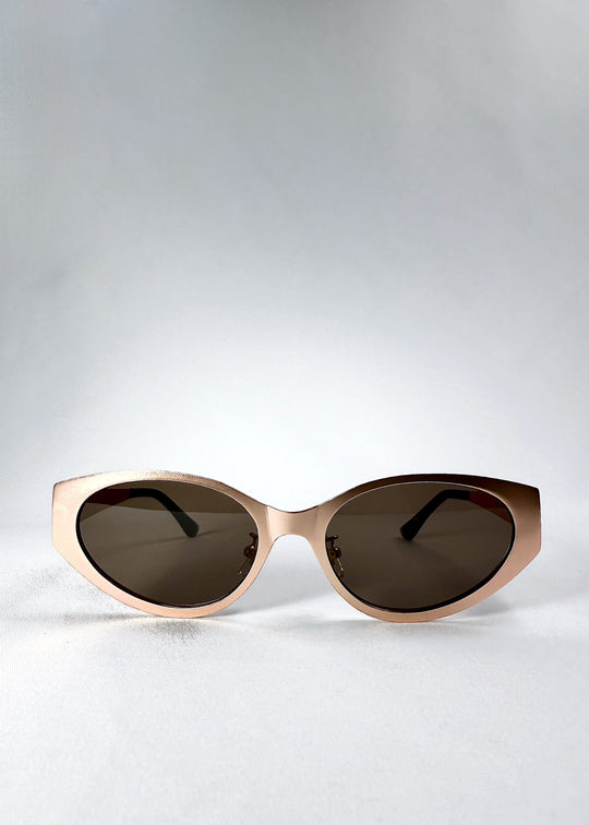 Front view of Nyx sunglasses in Mocha Dusk, showing the rose-gold cat-eye frame and deep tea lenses. 