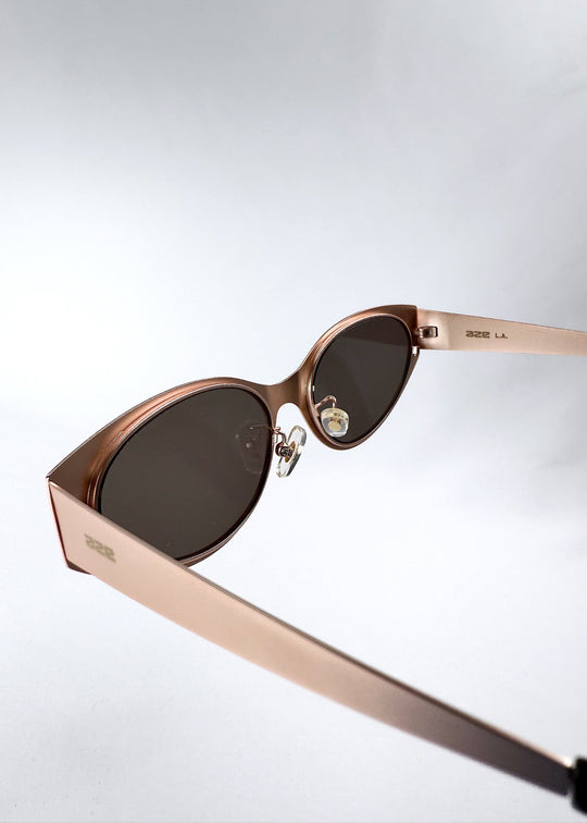 Inside view of Nyx sunglasses in Mocha Dusk, showing the lens curvature, bridge and adjustable nose pads. 