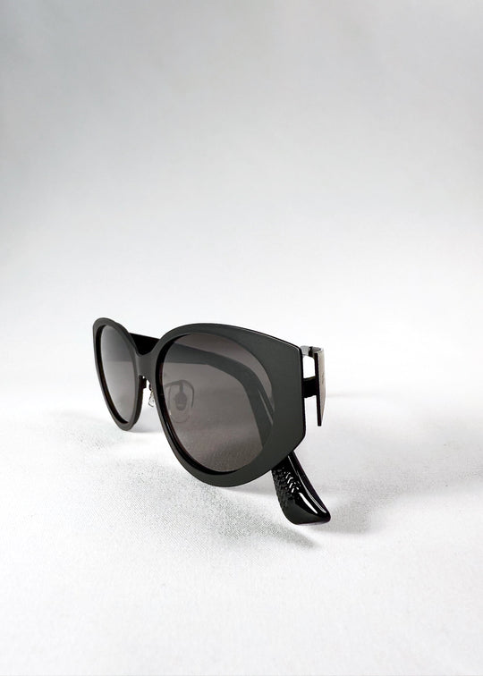 Folded view of Nyx sunglasses in Shadow Black, showing the compact frame and aligned hinges. 