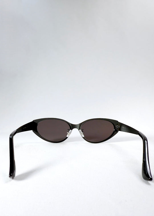 Inside back view of Nyx sunglasses in Shadow Black, showing the inner frame, adjustable nose pads and open temples. 