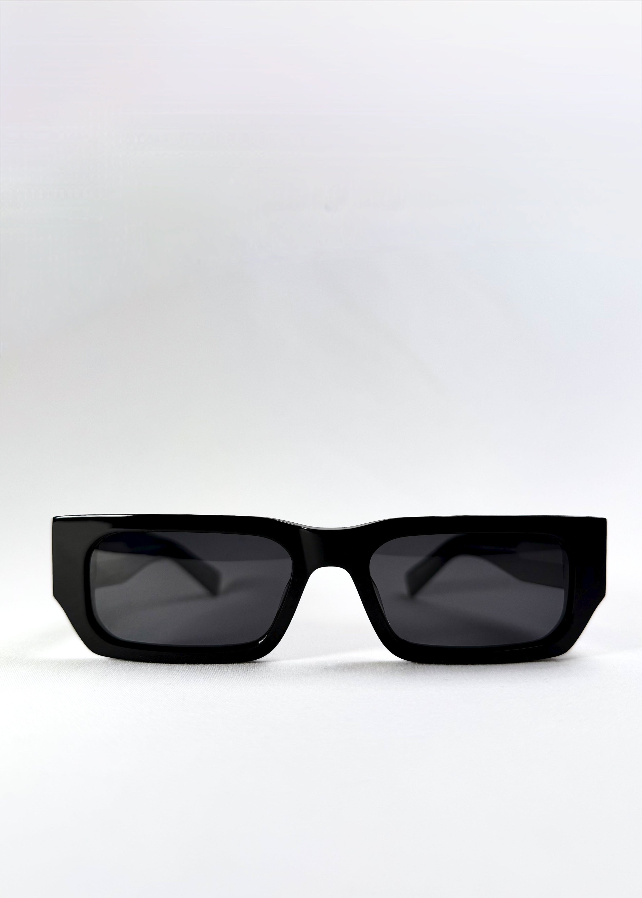 Front view of Oblivion Trace sunglasses in Obsidian Black, showing bold rectangular frame and dark polarized lenses.