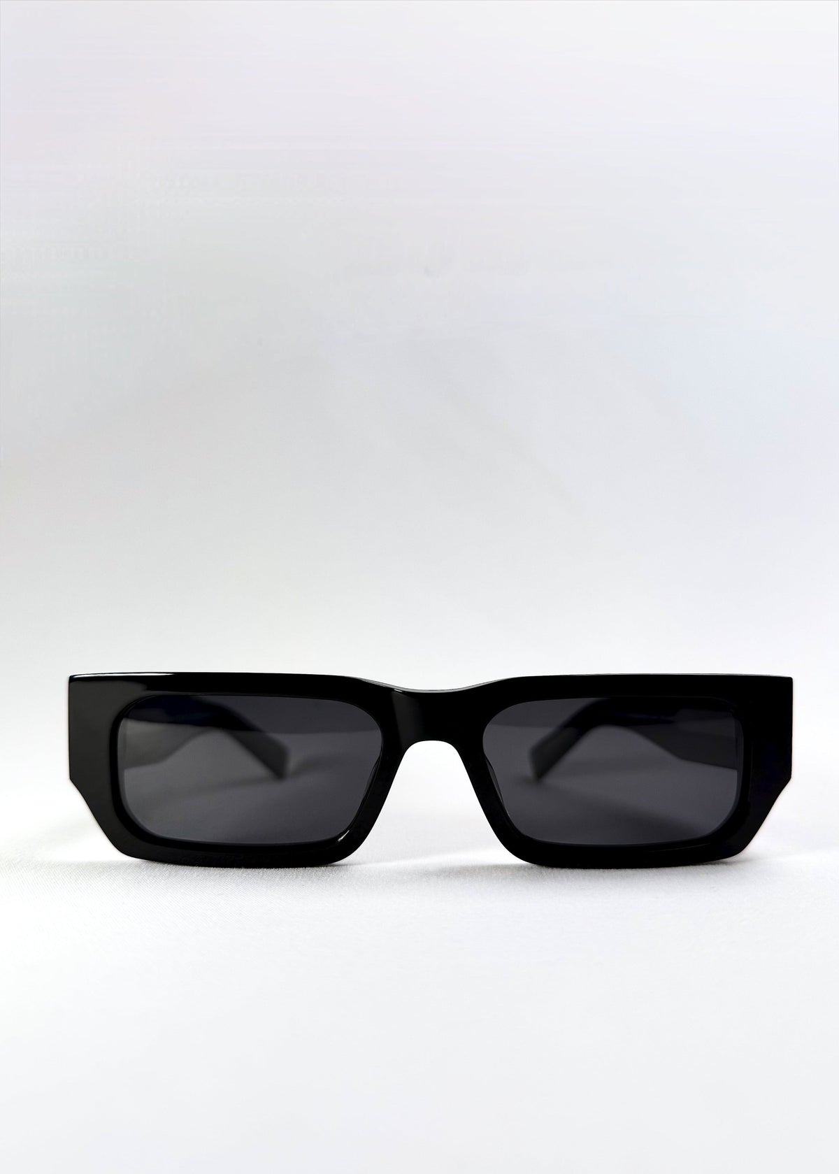 Front view of Oblivion Trace sunglasses in Obsidian Black, showing bold rectangular frame and dark polarized lenses.