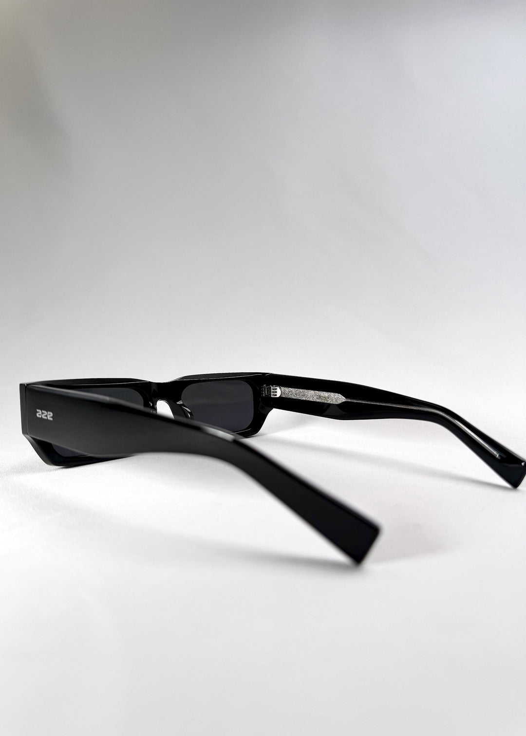 Side view of Oblivion Trace sunglasses in a folded position, featuring the wide temples and Aze logo. 