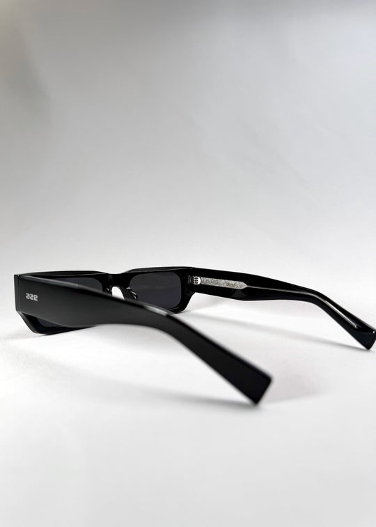 Side view of Oblivion Trace sunglasses in a folded position, featuring the wide temples and Aze logo. 