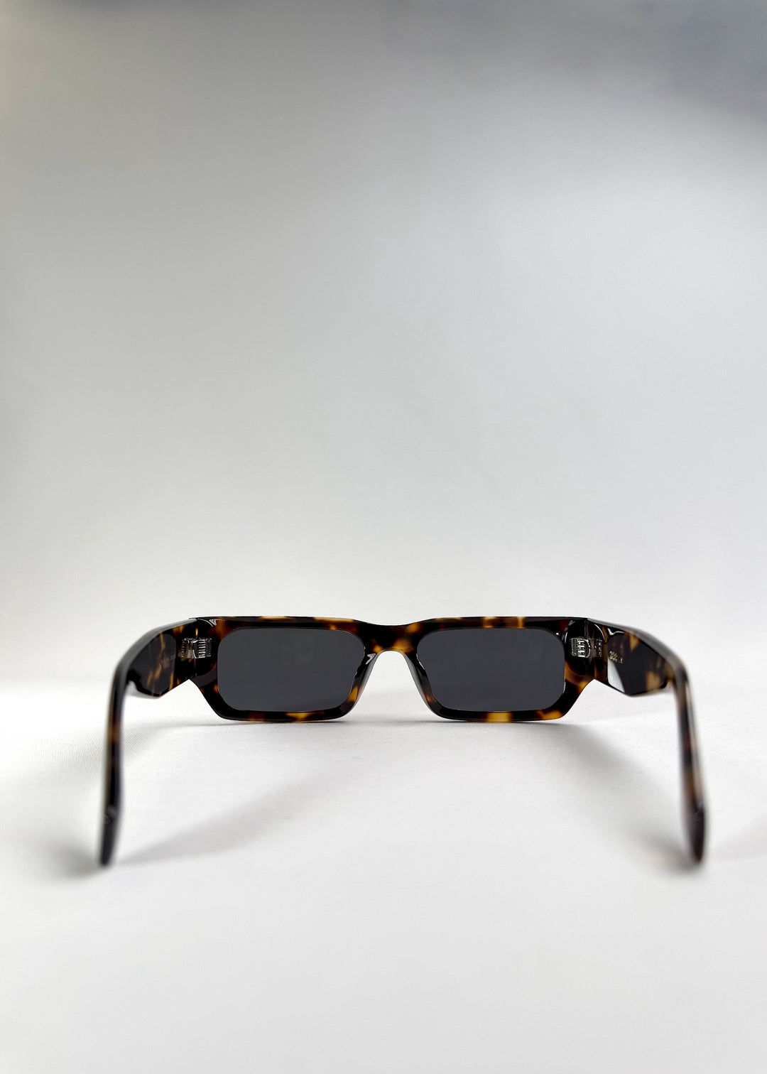 Back view of Oblivion Trace in Tortoise, emphasizing the wide arms and inner construction. 