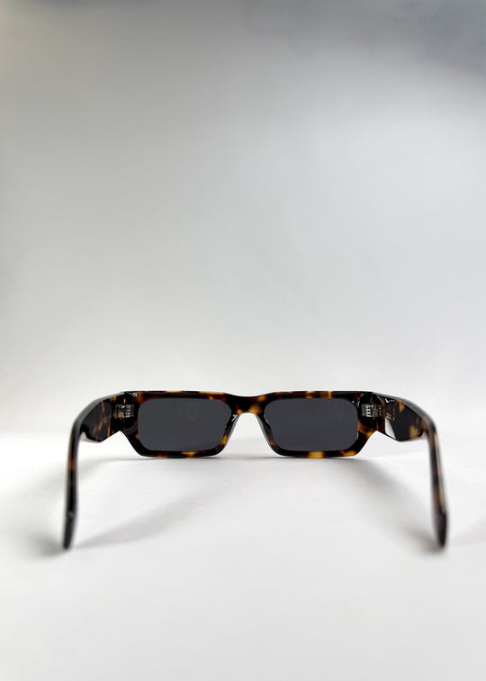 Back view of Oblivion Trace in Tortoise, emphasizing the wide arms and inner construction. 