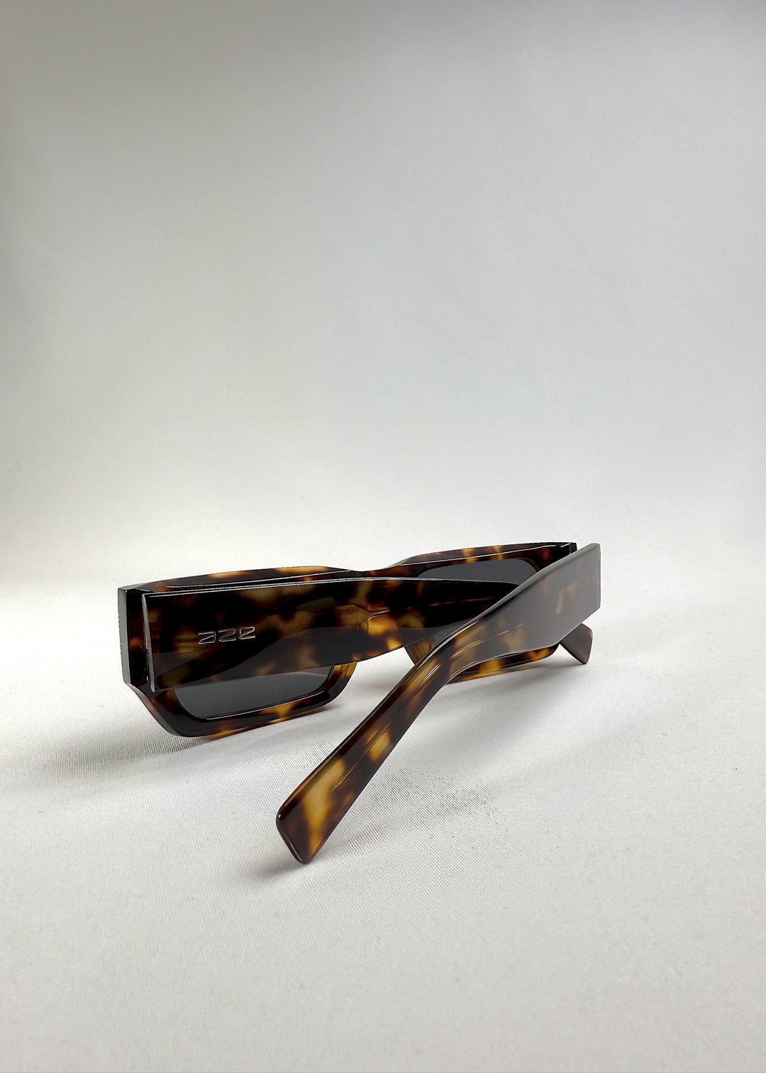 Folded view of Oblivion Trace in Tortoise, displaying the clean, geometric frame with AZE logo on the temple. 
